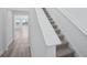 Carpeted staircase leading up to the second floor with white banister at 1801 Archer Dr, Minneola, FL 34715