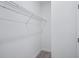 Compact walk-in closet with neutral carpet and white wire shelving at 1801 Archer Dr, Minneola, FL 34715