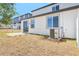 A modern backyard featuring a sliding glass door and AC unit at 1812 Archer Dr, Minneola, FL 34715