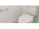 Close up of toilet with chrome fixtures in a pristine white bathroom at 1812 Archer Dr, Minneola, FL 34715