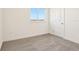 Bright bedroom features neutral carpet, white walls, and a window with scenic views at 1812 Archer Dr, Minneola, FL 34715