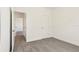 Neutrally carpeted bedroom with white walls and two doorways for easy access at 1812 Archer Dr, Minneola, FL 34715
