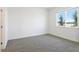 Empty bedroom featuring plush carpet, neutral paint, and a bright window at 1812 Archer Dr, Minneola, FL 34715