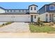 Charming two-story home featuring a paved driveway, attached garage, and landscaped front yard at 1812 Archer Dr, Minneola, FL 34715