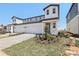Charming two-story home featuring a paved driveway, attached garage, and landscaped front yard at 1812 Archer Dr, Minneola, FL 34715