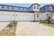 Charming two-story home featuring a paved driveway, attached garage, and landscaped front yard at 1812 Archer Dr, Minneola, FL 34715