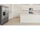 The kitchen has stainless appliances, white cabinets, a large island and stylish countertops at 1812 Archer Dr, Minneola, FL 34715