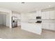 A spacious kitchen featuring white cabinets, stainless steel appliances, and a large island at 1812 Archer Dr, Minneola, FL 34715