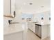 Bright kitchen features white cabinets, stainless steel appliances, an island with sink, and expansive countertops at 1812 Archer Dr, Minneola, FL 34715