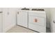 Laundry room with new white washer and dryer with updated hardware at 1812 Archer Dr, Minneola, FL 34715