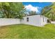 A spacious backyard includes a grassy area, a white fence, and a storage shed at 1845 Delaney Ave, Orlando, FL 32806