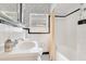 Classic bathroom featuring white tile, a sink, and black and white accents that offer a clean and timeless look at 1845 Delaney Ave, Orlando, FL 32806