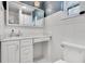 Bright bathroom with white tile, vanity, and a mirrored medicine cabinet for ample storage space at 1845 Delaney Ave, Orlando, FL 32806
