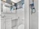 Bathroom featuring white tiled walls and vanity with a mirrored medicine cabinet and shower at 1845 Delaney Ave, Orlando, FL 32806