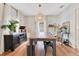 Spacious dining room with hardwood floors, long table, industrial chairs, and statement lighting at 1845 Delaney Ave, Orlando, FL 32806