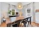 Bright dining room with hardwood floors, farmhouse table, chandelier and lots of light at 1845 Delaney Ave, Orlando, FL 32806