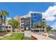 Modern exterior of a hospital building featuring directional signage and manicured landscaping at 1845 Delaney Ave, Orlando, FL 32806