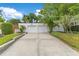 Detached two-car garage with a concrete driveway and beautifully landscaped yard at 1845 Delaney Ave, Orlando, FL 32806