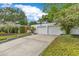 Two-car detached garage with concrete driveway and low shrubbery at 1845 Delaney Ave, Orlando, FL 32806