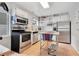 Bright kitchen featuring stainless steel appliances, white cabinets, and an island at 1845 Delaney Ave, Orlando, FL 32806