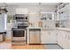 Updated kitchen featuring stainless steel appliances, white subway tile, and ample cabinet space at 1845 Delaney Ave, Orlando, FL 32806