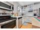 Bright kitchen featuring stainless steel appliances, white cabinets, and subway tile backsplash at 1845 Delaney Ave, Orlando, FL 32806