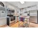 Charming kitchen featuring stainless steel appliances, white cabinets, and an island at 1845 Delaney Ave, Orlando, FL 32806