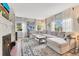 Bright living room with hardwood floors, a large sectional, fireplace, and built-in shelving at 1845 Delaney Ave, Orlando, FL 32806