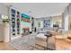 Bright living room with hardwood floors, a large sectional, fireplace, and built-in shelving at 1845 Delaney Ave, Orlando, FL 32806