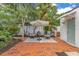 This patio features brick flooring, outdoor seating, and an umbrella at 1845 Delaney Ave, Orlando, FL 32806