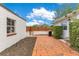 A brick-paved backyard patio is fenced for privacy, ideal for outdoor relaxation and grilling at 1845 Delaney Ave, Orlando, FL 32806