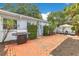A brick-paved backyard patio offers a grill and seating, ideal for outdoor dining at 1845 Delaney Ave, Orlando, FL 32806