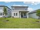 View of home exterior with a covered patio and green lawn at 1904 Archer Dr, Minneola, FL 34715