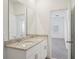 Bathroom featuring double vanity with granite counters at 1904 Archer Dr, Minneola, FL 34715