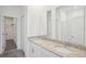 Bathroom featuring double sinks, granite countertops, and modern fixtures at 1904 Archer Dr, Minneola, FL 34715