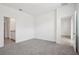 Cozy bedroom with plush carpet, ample space, and seamless access to the bathroom and closet at 1904 Archer Dr, Minneola, FL 34715