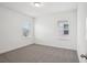 A bright bedroom features plush carpet, two windows and neutral paint at 1904 Archer Dr, Minneola, FL 34715