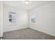 A bright bedroom features plush carpet, two windows and neutral paint at 1904 Archer Dr, Minneola, FL 34715