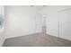 A bright bedroom features plush carpet, neutral paint and a closet at 1904 Archer Dr, Minneola, FL 34715