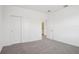 Bedroom with carpet, double door closet, and a door leading to a bathroom at 1904 Archer Dr, Minneola, FL 34715