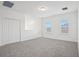 Bright upstairs bonus room features plush carpet, windows, and a large closet at 1904 Archer Dr, Minneola, FL 34715
