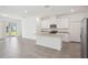 Open-concept kitchen featuring a center island, granite countertops, and stainless steel appliances at 1904 Archer Dr, Minneola, FL 34715
