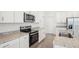 Bright kitchen with stainless steel appliances, granite countertops, and a central island with a sink at 1904 Archer Dr, Minneola, FL 34715