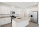 Modern kitchen with granite countertops, stainless steel appliances, and white cabinetry at 1904 Archer Dr, Minneola, FL 34715