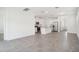 Bright, open-concept living space features tile flooring and a modern kitchen with stainless steel appliances at 1904 Archer Dr, Minneola, FL 34715