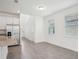 Open-concept living room featuring an adjacent kitchen, tile floors, and an airy atmosphere at 1904 Archer Dr, Minneola, FL 34715