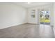 Neutral living area boasts tile floors and sliding glass doors to the backyard at 1904 Archer Dr, Minneola, FL 34715