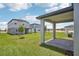 Covered patio overlooking the landscaped backyard and neighboring homes at 1904 Archer Dr, Minneola, FL 34715