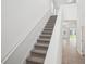 Bright staircase with carpeted steps leading to the upper level of the home at 1904 Archer Dr, Minneola, FL 34715