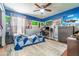 Bright bedroom with a blue accent wall, ceiling fan, and large area rug at 1993 Excalibur Dr, Orlando, FL 32822